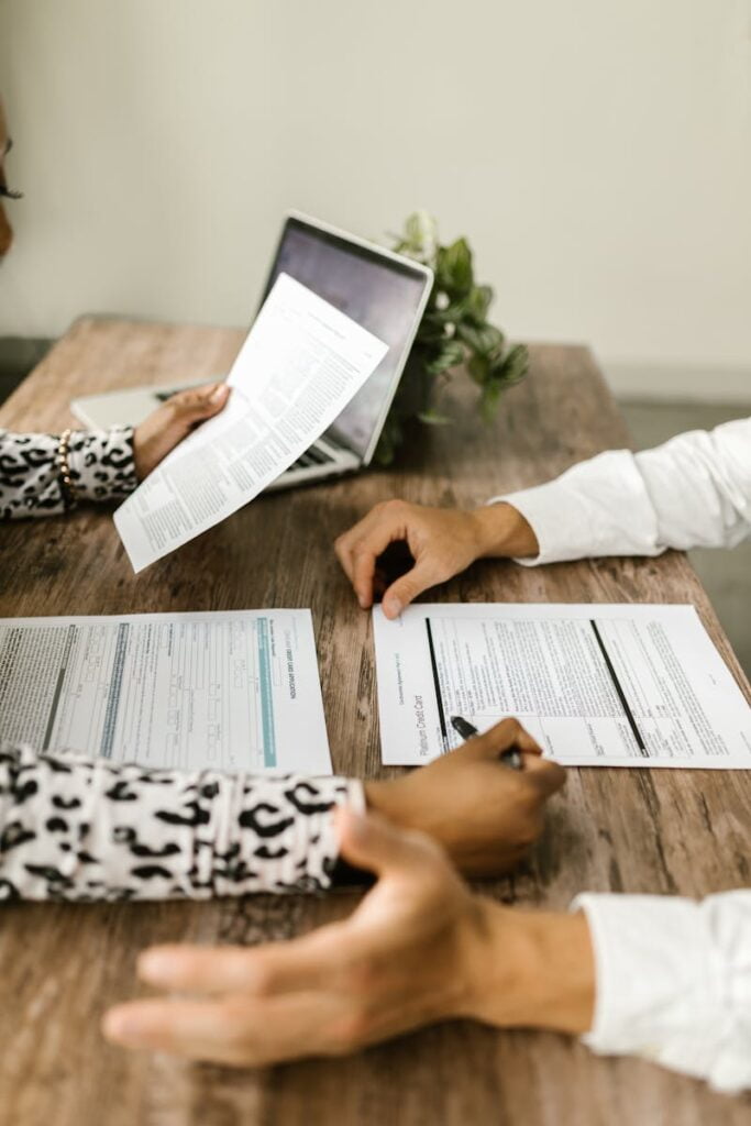 Man and Woman Sitting at Table with Papers